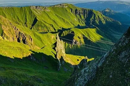 Vue panoramique d’un paysage verdoyant et vallonné en Auvergne.